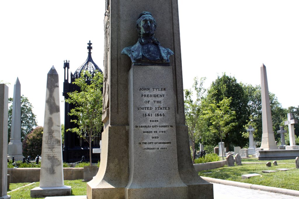 A closer view of the bust on Tyler's monument. President Monroe's tomb is visible in the background. - <i>Photo by John Dolan</i>