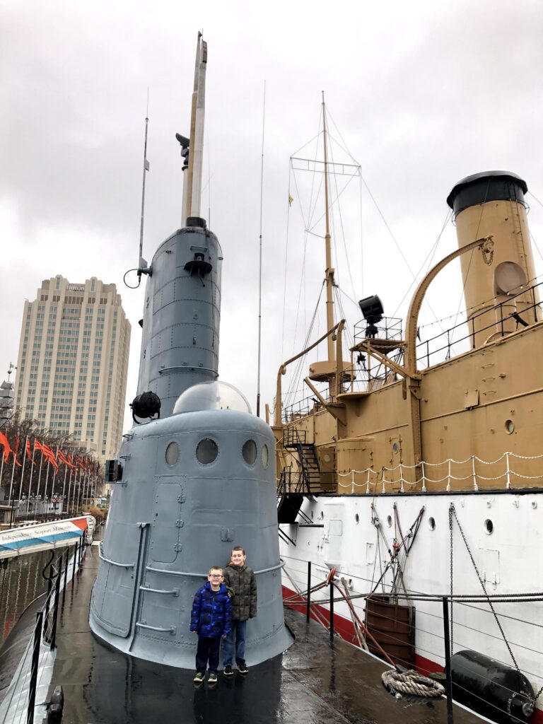 My boys aboard the <i>Becuna</i> with the <i>Olympia</i> in the background. - <i>Photo by the author</i>