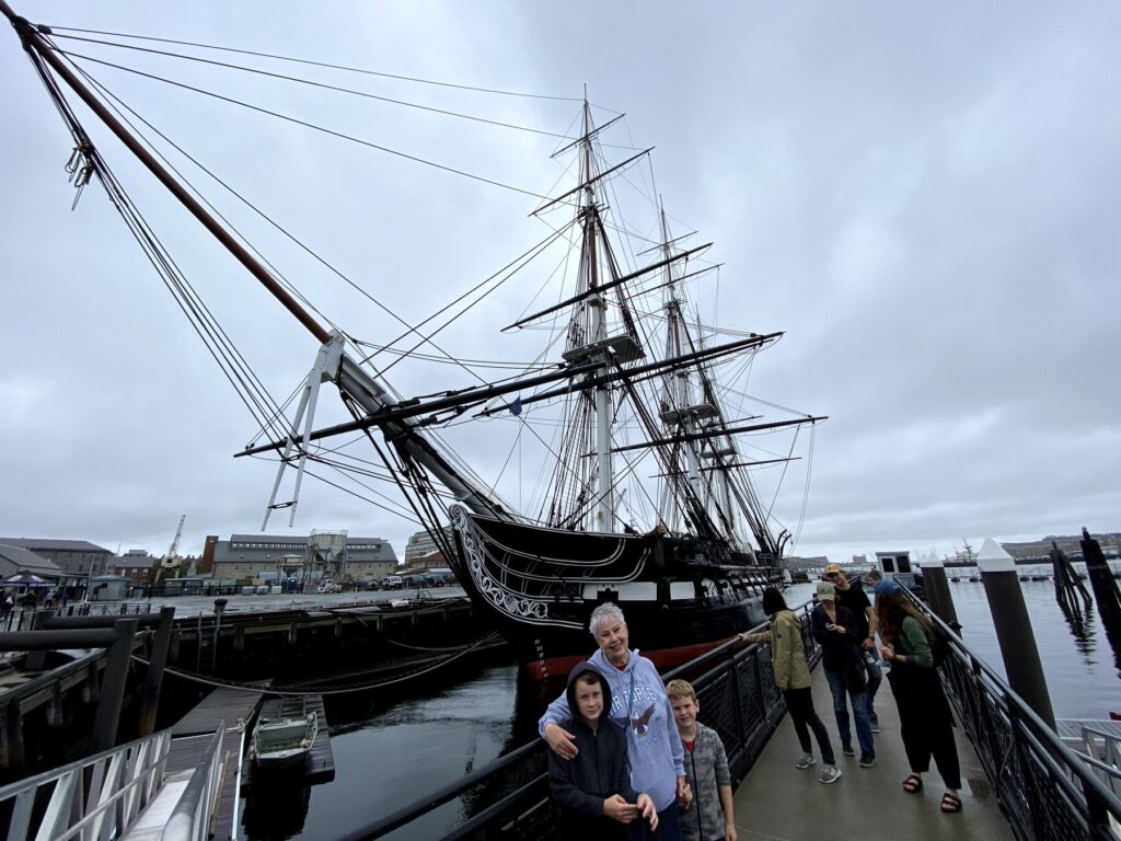 The boys pose with "Nene" in front of the USS <i>Constitution</i>. - <i>Photo by the author</i>
