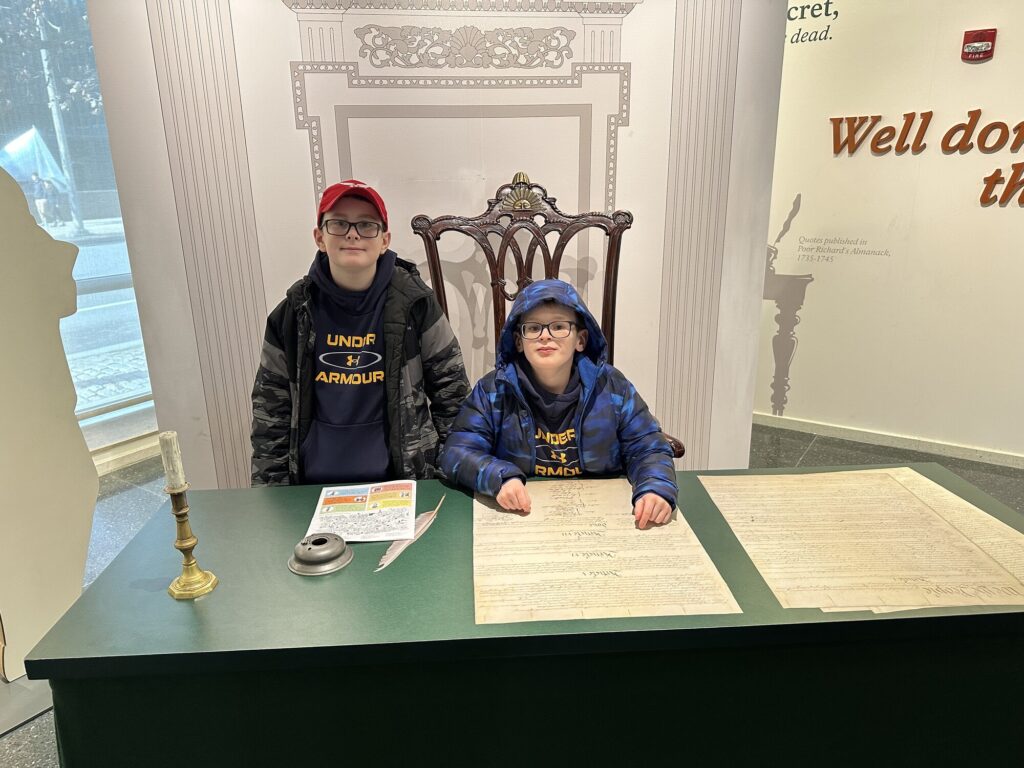 John stands by as Isaac presides over the signing of the Constitution. - <i>Photo by the author</i>