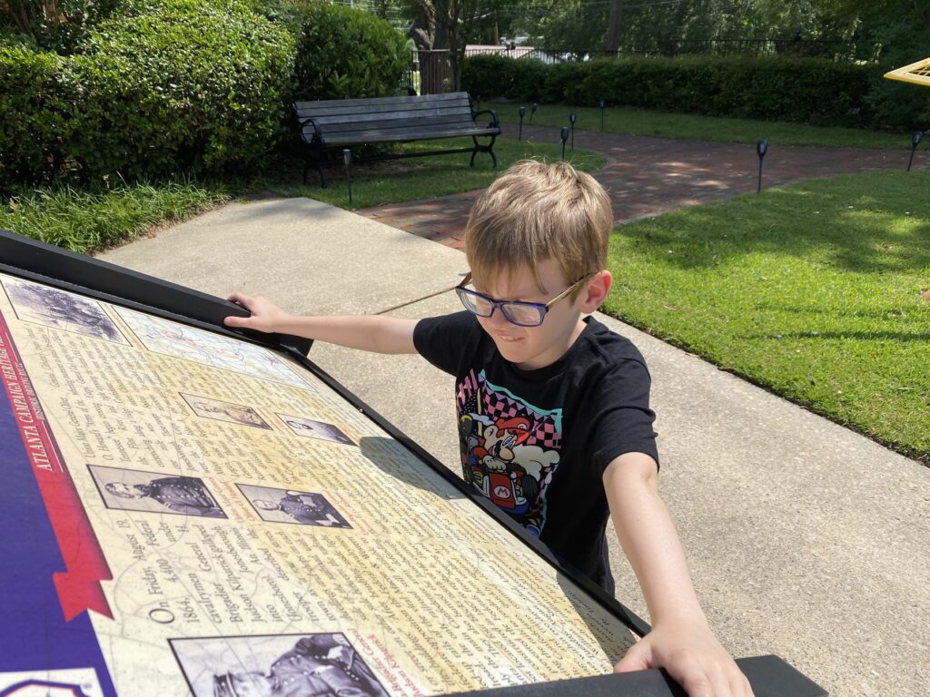 Examining a wayside marker for the Battle of Jonesborough. - <i>Photo by the author</i>