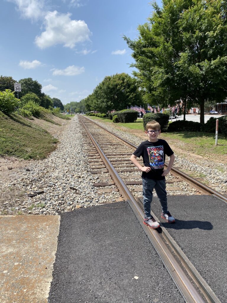 Isaac poses along the tracks of the old Macon & Western Railroad. - <i>Photo by the author</i>