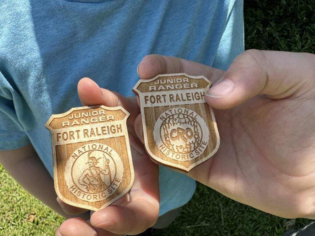 Fort Raleigh has two different designs for their Junior Ranger badges. The boys got one of each. - <i>Photo by the author</i>