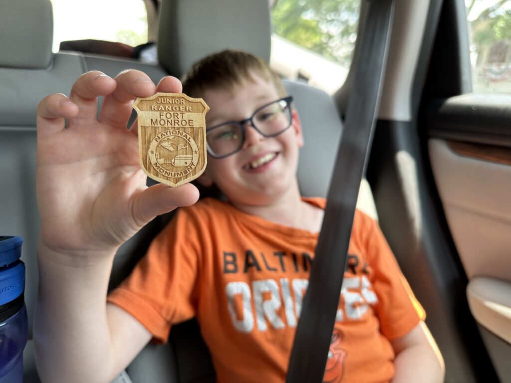 Isaac proudly holds his Fort Monroe Junior Ranger badge. - <i>Photo by the author</i>