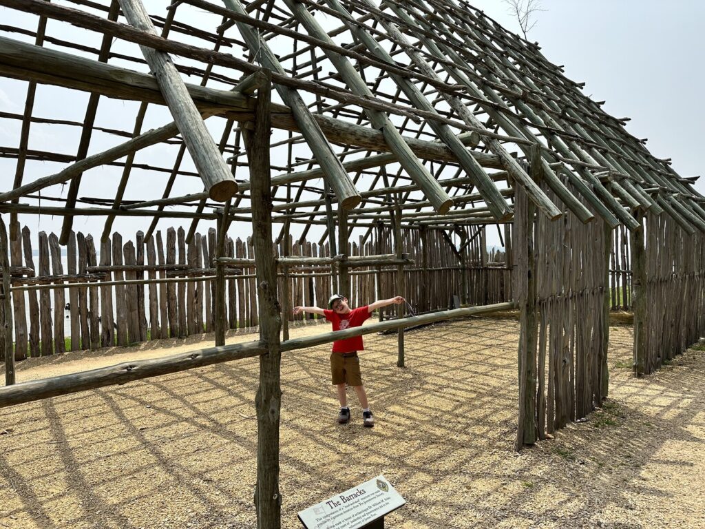 Isaac explores the reconstructed barracks. - <i>Photo by the author</i>