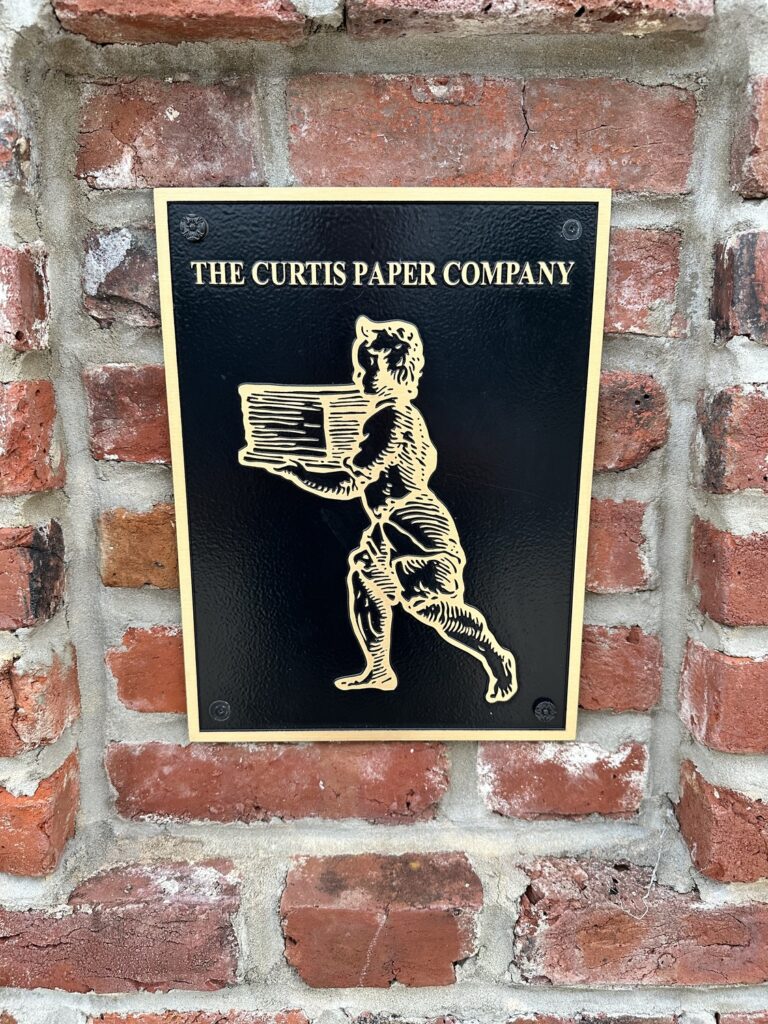 A plaque with the brand of the Curtis Paper Mill is at the site today. - <i>Photo by the author</i>