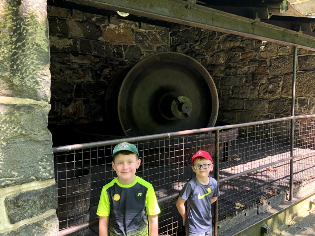 John and Isaac in front of one of the large rolling mills. - <i>Photo by the author</i>