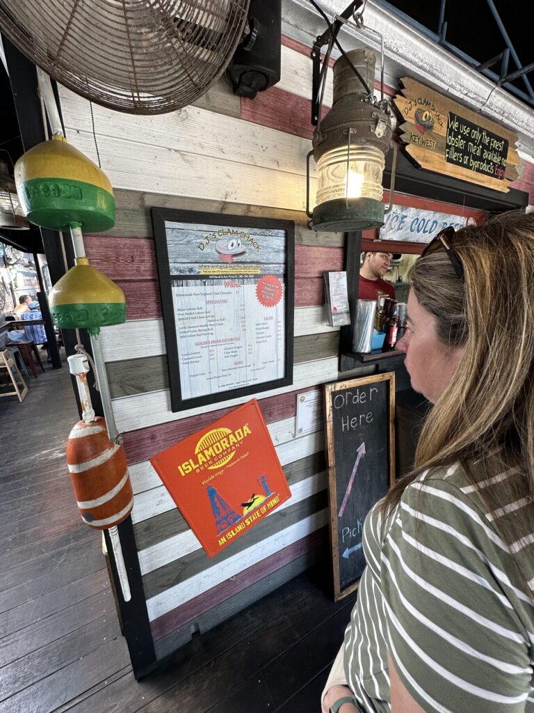 Emily inspects the menu at DJ's Clam Shack - <i>Photo by the author</i>