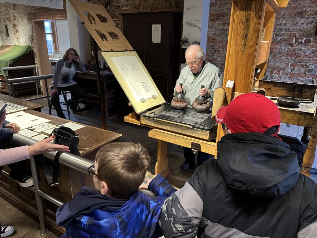 The boys were very interested in the print shop demonstration. - <i>Photo by the author</i>
