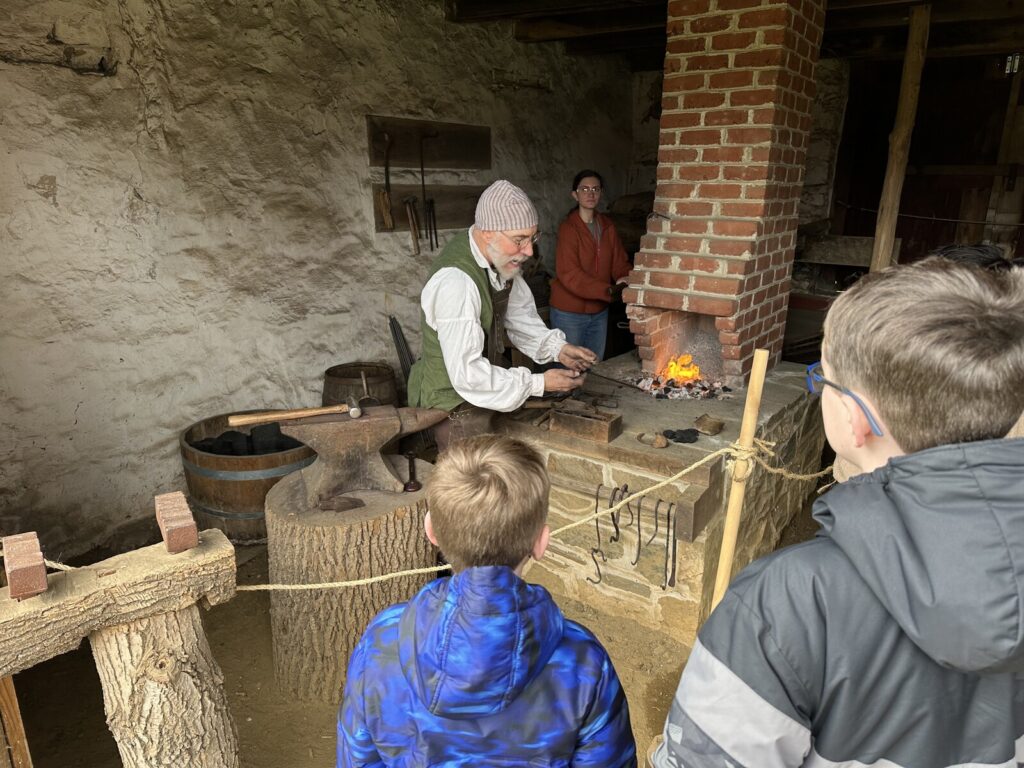 Watching the blacksmith demo. - <i>Photo by the author</i>